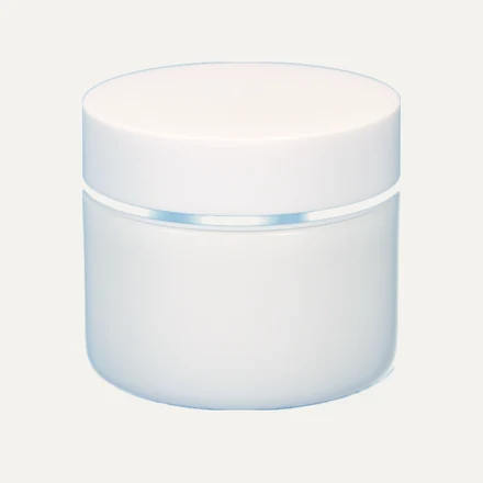 A white straight-sided cosmetic jar with a printed label applied
